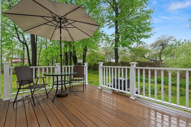 wooden deck featuring outdoor dining area