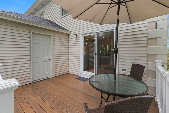 wooden terrace featuring outdoor dining space
