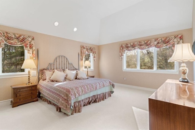 bedroom with light colored carpet and multiple windows