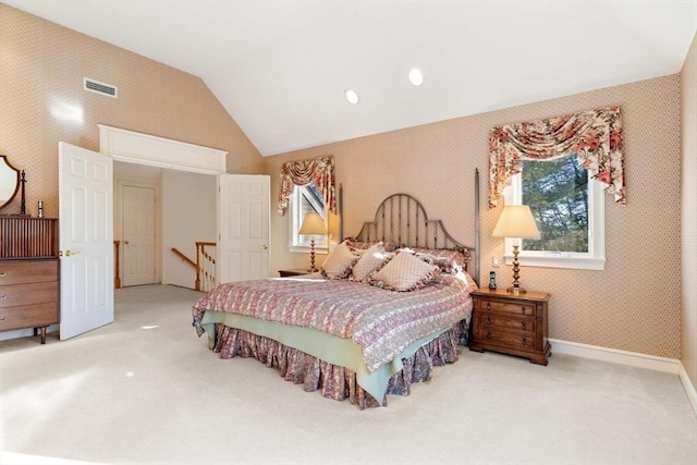 carpeted bedroom with vaulted ceiling