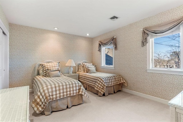 carpeted bedroom featuring multiple windows