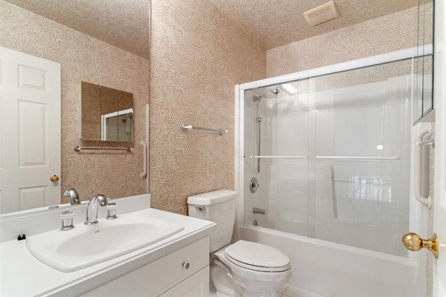 full bathroom featuring vanity, toilet, and combined bath / shower with glass door