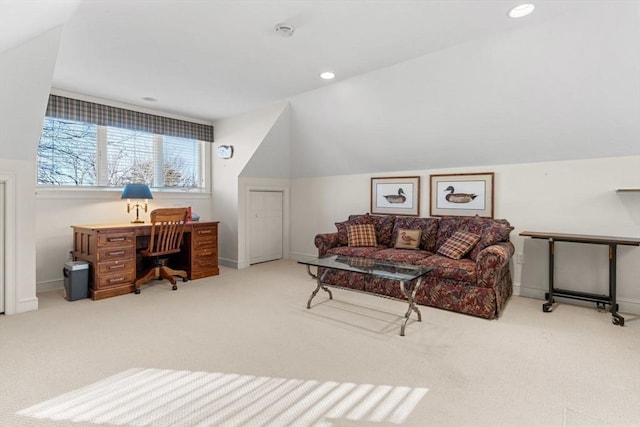 carpeted office space featuring lofted ceiling