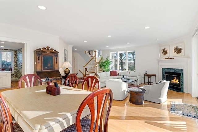 dining space featuring a fireplace and light hardwood / wood-style floors