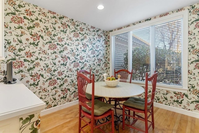 dining room with wood-type flooring and a healthy amount of sunlight