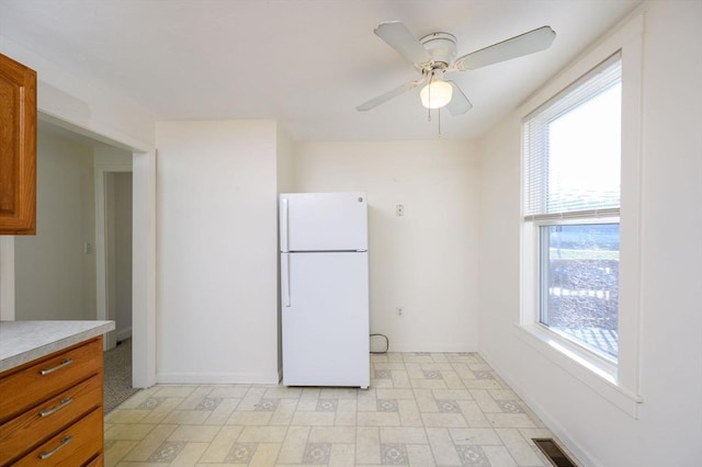 kitchen featuring ceiling fan and white fridge