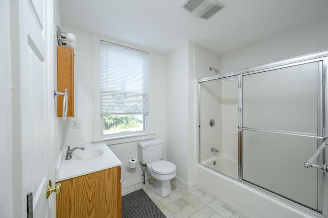 full bathroom featuring vanity, toilet, and combined bath / shower with glass door