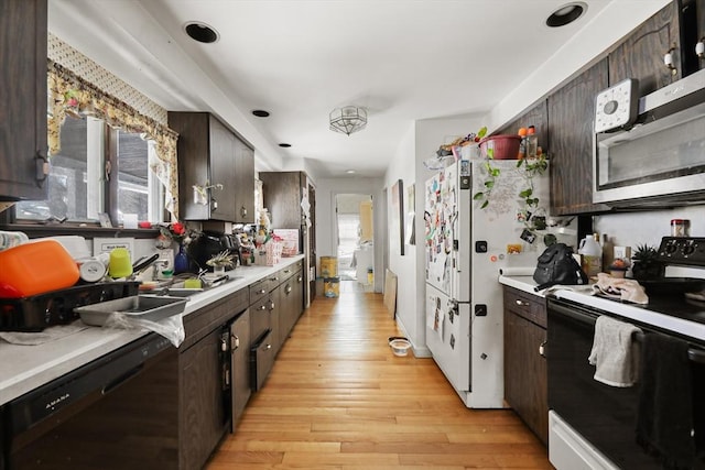 kitchen with black appliances, light countertops, light wood-style flooring, and dark brown cabinetry