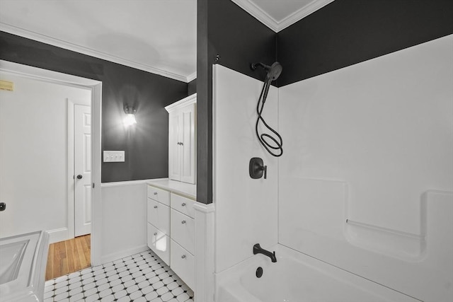 bathroom with ornamental molding, shower / washtub combination, and vanity