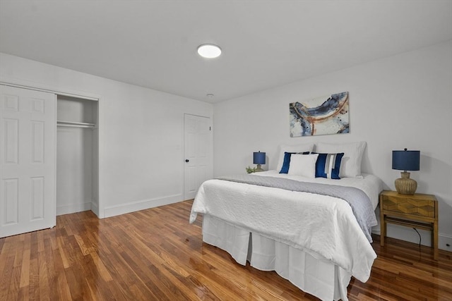 bedroom featuring hardwood / wood-style flooring and a closet