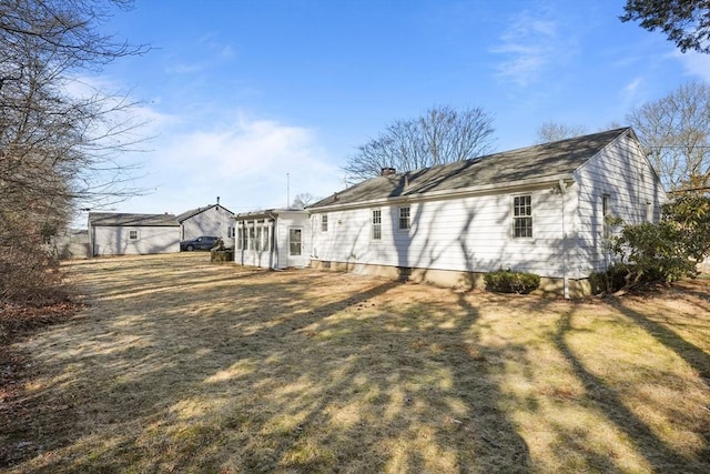 rear view of property featuring a yard