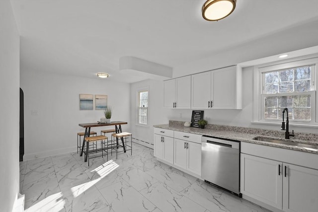 kitchen featuring dishwasher, sink, white cabinets, a baseboard heating unit, and light stone countertops