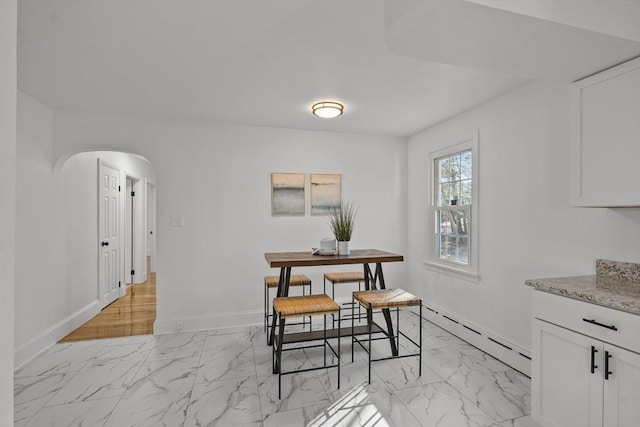 dining space with a baseboard heating unit