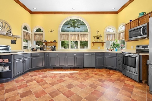 311 Main St, Franklin, MA 02038 - kitchen with gray cabinetry, stainless steel appliances, open shelves, crown molding, and light countertops