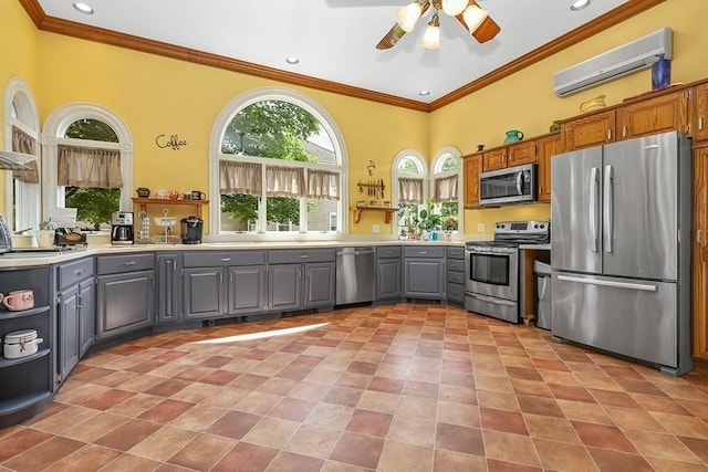 311 Main St, Franklin, MA 02038 - kitchen with appliances with stainless steel finishes, gray cabinets, an AC wall unit, ornamental molding, and a ceiling fan