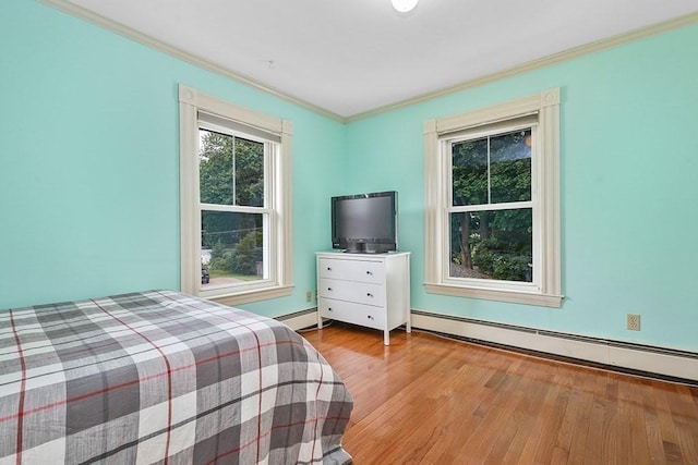 311 Main St, Franklin, MA 02038 - bedroom with ornamental molding, wood finished floors, and a baseboard radiator