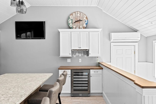 16 W Wind Acres, Norwell, MA 02061 - indoor dry bar featuring wine cooler, a wall mounted AC, vaulted ceiling, light wood-type flooring, and wood ceiling