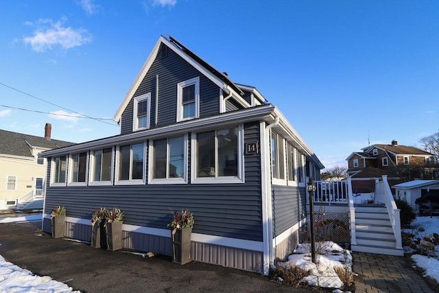 view of snowy exterior featuring a deck