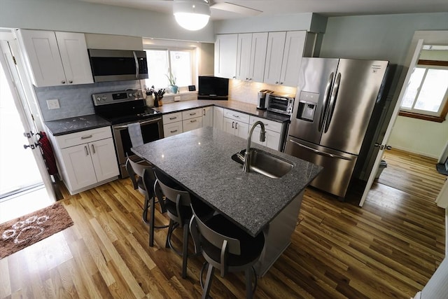 kitchen with white cabinetry, sink, and appliances with stainless steel finishes