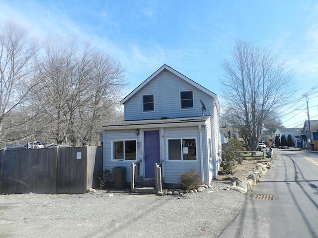 shotgun-style home featuring fence