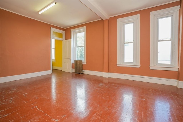 unfurnished room featuring radiator, beamed ceiling, and hardwood / wood-style flooring