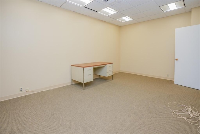 unfurnished room featuring light carpet and a paneled ceiling