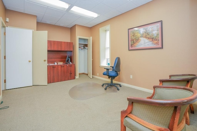 sitting room with a drop ceiling and light colored carpet