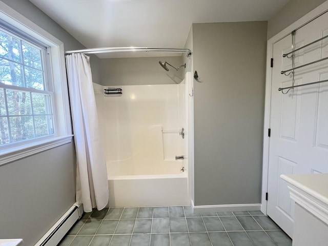 bathroom with baseboards, baseboard heating, shower / bath combo, and tile patterned floors