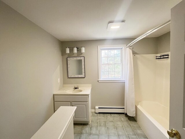 full bathroom with tile patterned floors, shower / bathtub combination with curtain, a baseboard heating unit, and vanity