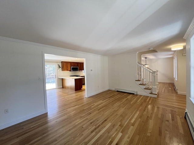 unfurnished living room with a baseboard radiator, stairs, baseboards, and wood finished floors