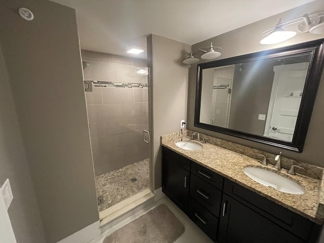 bathroom featuring tile patterned flooring, vanity, and walk in shower