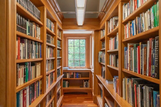 living area featuring wood finished floors and bookshelves