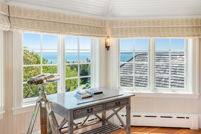 sunroom / solarium featuring a baseboard heating unit, vaulted ceiling with beams, and a water view