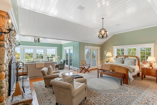 bedroom with a stone fireplace, wood ceiling, vaulted ceiling, french doors, and a chandelier