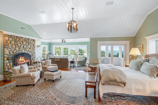 bedroom featuring a fireplace, hardwood / wood-style flooring, vaulted ceiling, and wood ceiling