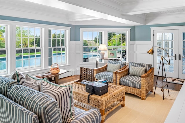 sunroom / solarium with beamed ceiling, a wealth of natural light, and french doors