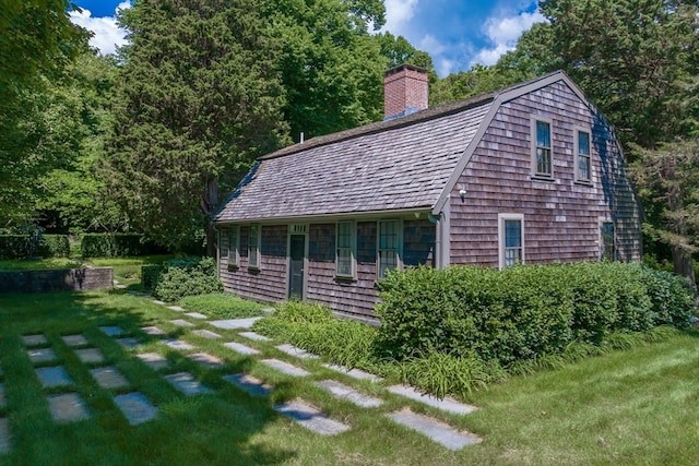 view of side of home with a yard