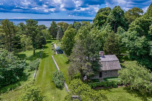 aerial view with a water view and a wooded view