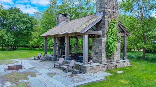 view of property's community featuring a patio, a gazebo, and a yard