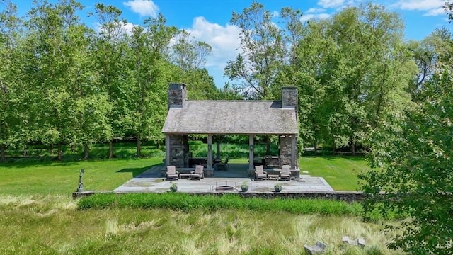surrounding community with a patio and a yard
