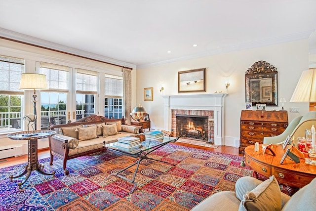 living area featuring ornamental molding, wood finished floors, recessed lighting, and a brick fireplace