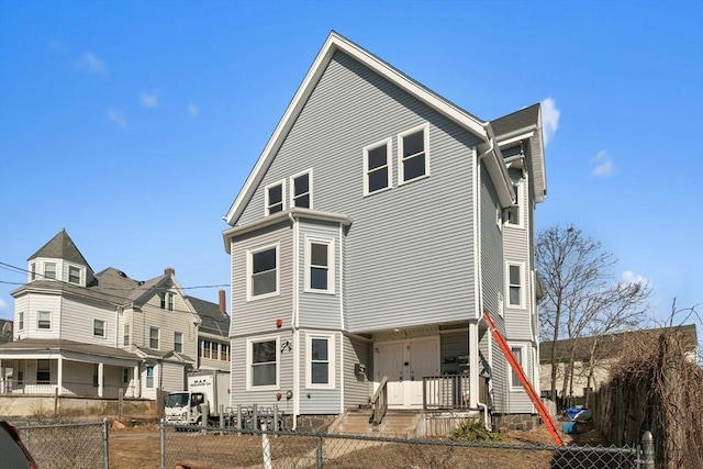 back of property featuring a fenced front yard