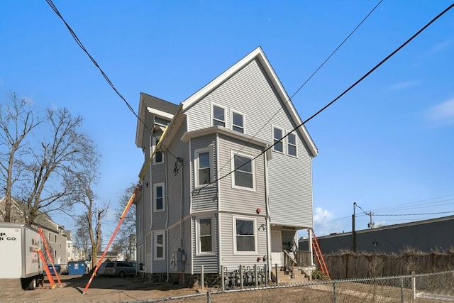 back of house with a fenced front yard