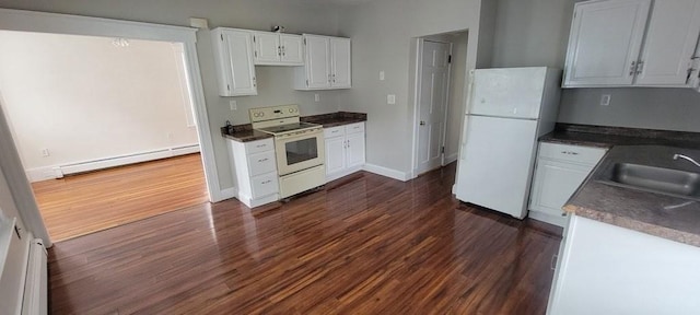 kitchen with dark countertops, a sink, white appliances, dark wood finished floors, and a baseboard radiator