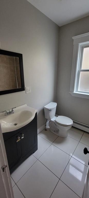 half bathroom with tile patterned floors, baseboard heating, vanity, and toilet