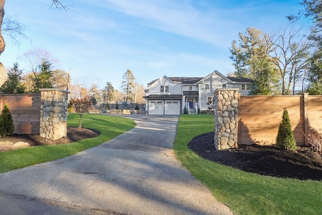 view of front facade with a front yard and a garage