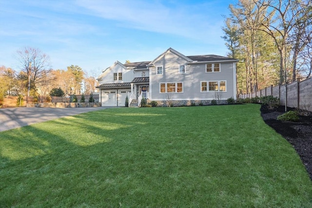 view of front of house with a front yard and a garage