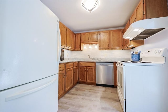 330 Thurston St Unit 330, Wrentham, MA 02093 - kitchen featuring white appliances, under cabinet range hood, light countertops, light wood finished floors, and decorative backsplash