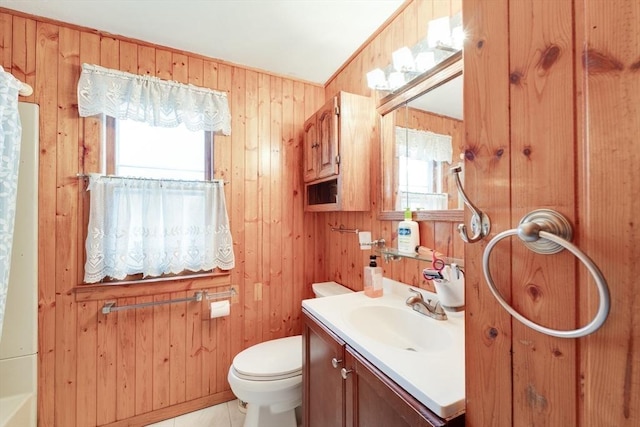 bathroom featuring toilet, vanity, tile patterned flooring, and wooden walls