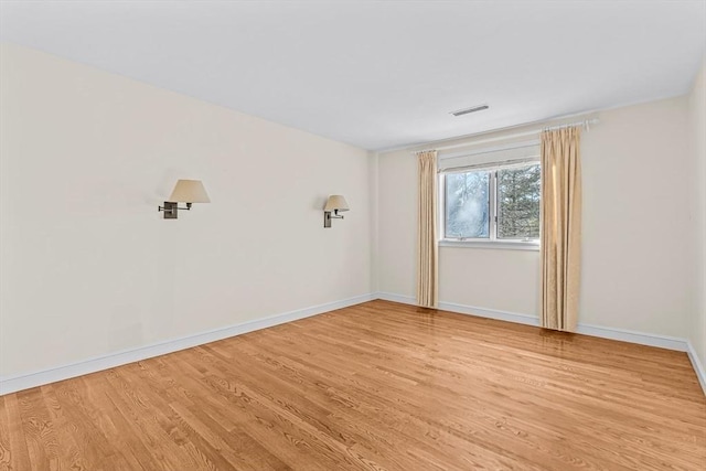 empty room with light hardwood / wood-style floors